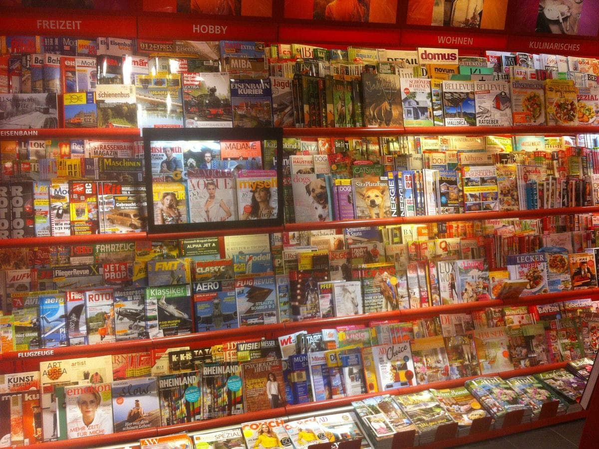 Photo: Rm1911 (CC BY-SA 4.0), via Wikimedia Commons A newsstand rack full of printed magazines